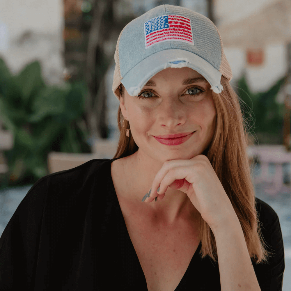 Woman sporting an American flag denim trucker hat