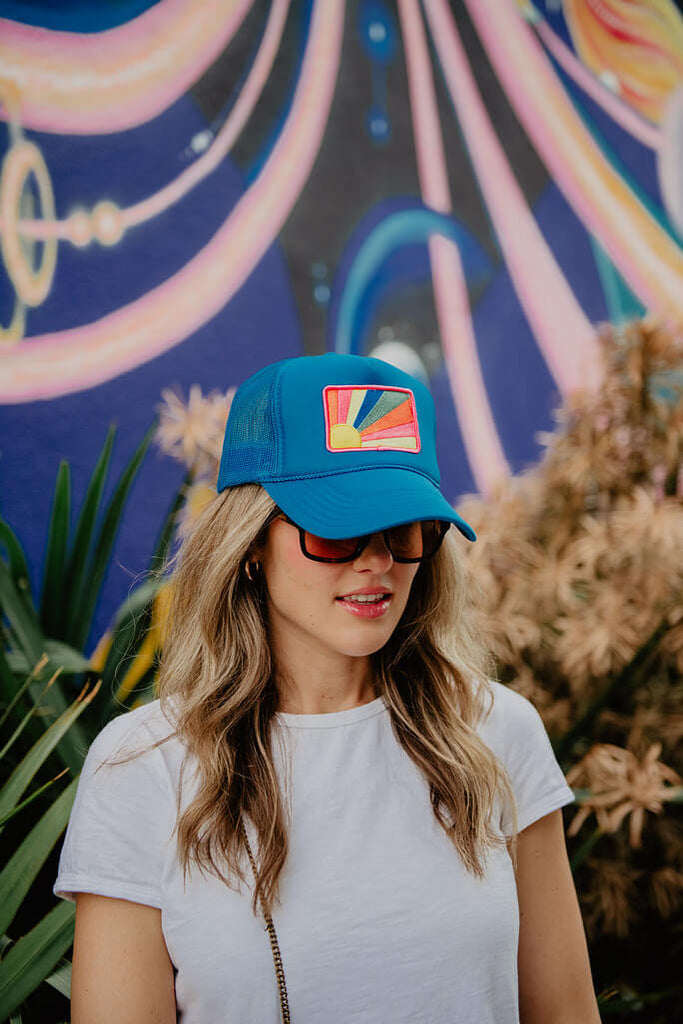 A woman with a blue trucker hat