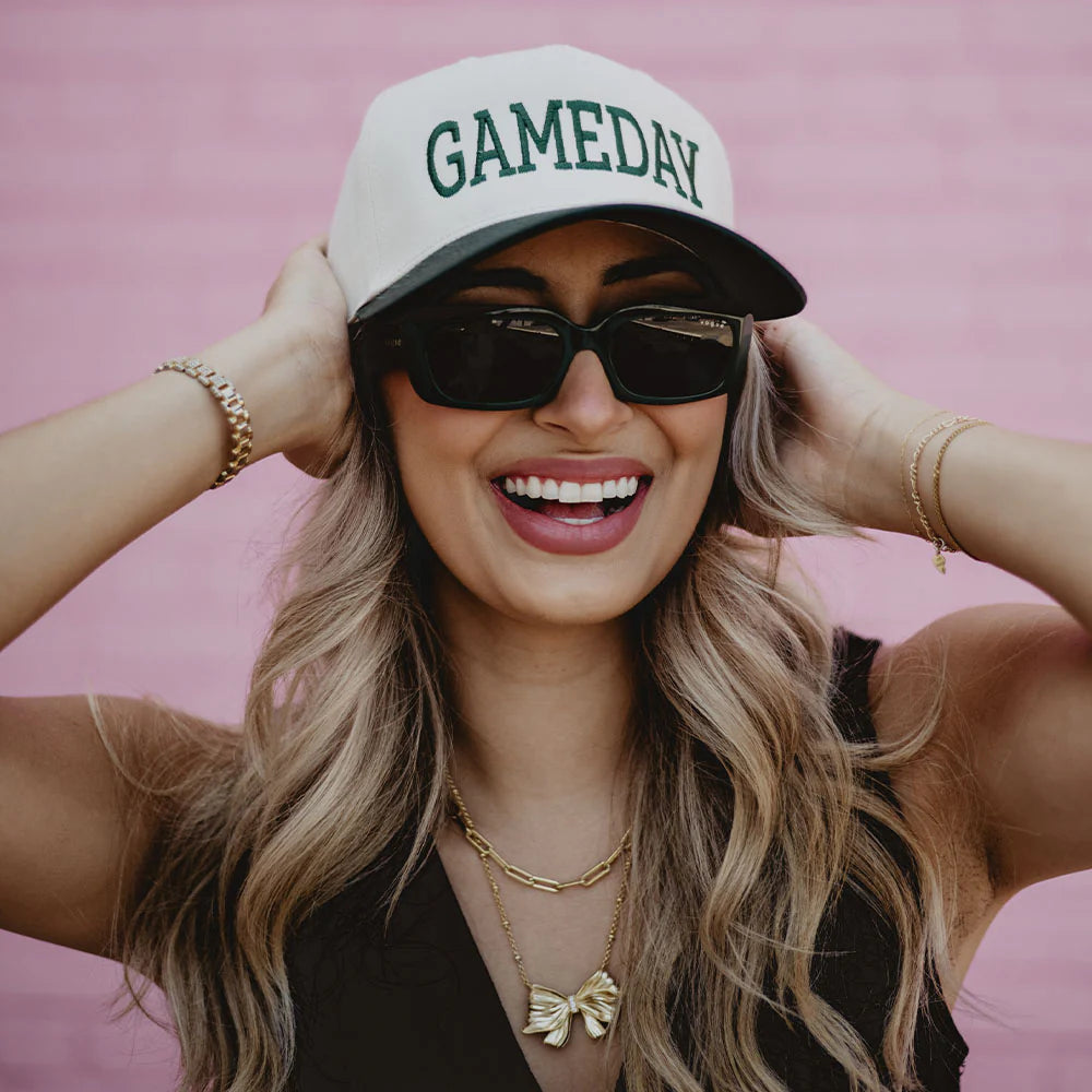 A woman styling a trucker hat with a casual getup