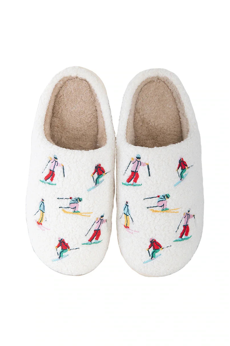 Relax in style with Katydids Apres Ski Winter Slippers—featuring a tan fuzzy sherpa lining and colorful embroidered skiers—perfect cozy après ski footwear.