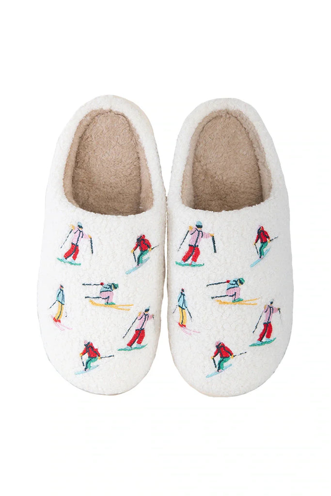 Relax in style with Katydids Apres Ski Winter Slippers—featuring a tan fuzzy sherpa lining and colorful embroidered skiers—perfect cozy après ski footwear.