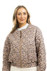 A woman with long, wavy blonde hair models the Katydid Brown Leopard Quilted Jacket over a white top, standing against a plain white background.