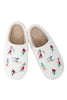 The Katydid Apres Ski Winter Slippers are white sherpa slippers with soft beige lining and feature colorful embroidered skiers on top.