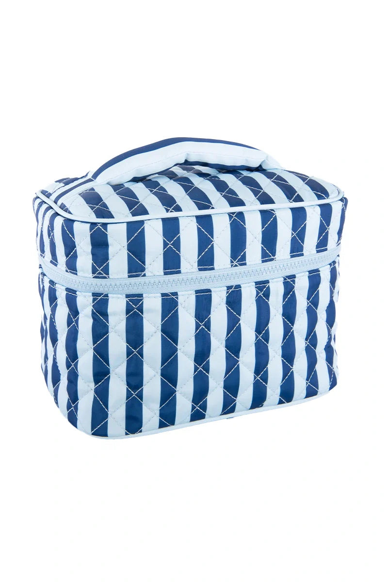 The Katydid Light Blue and Navy Striped Makeup Travel Bag features quilted fabric, blue and white stripes, a zipper closure, and a top handle—perfect for travel. Shown against a white background.