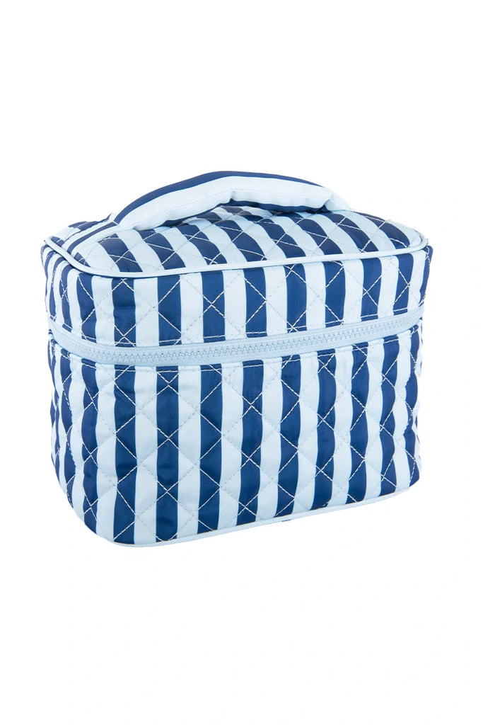 The Katydid Light Blue and Navy Striped Makeup Travel Bag features quilted fabric, blue and white stripes, a zipper closure, and a top handle—perfect for travel. Shown against a white background.