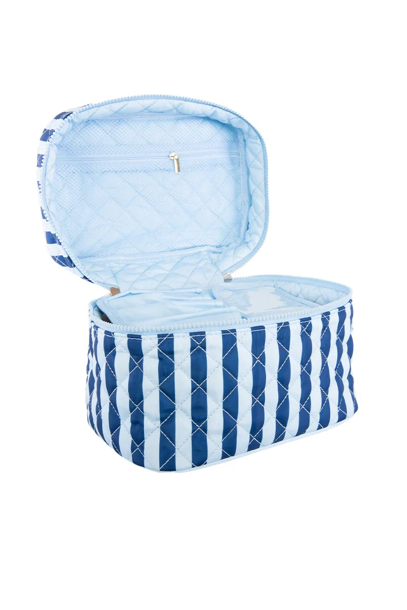 The Katydid Light Blue and Navy Striped Makeup Travel Bag is shown open, displaying its light blue interior with a zippered pocket inside the lid—an ideal quilted cosmetic bag for travel.