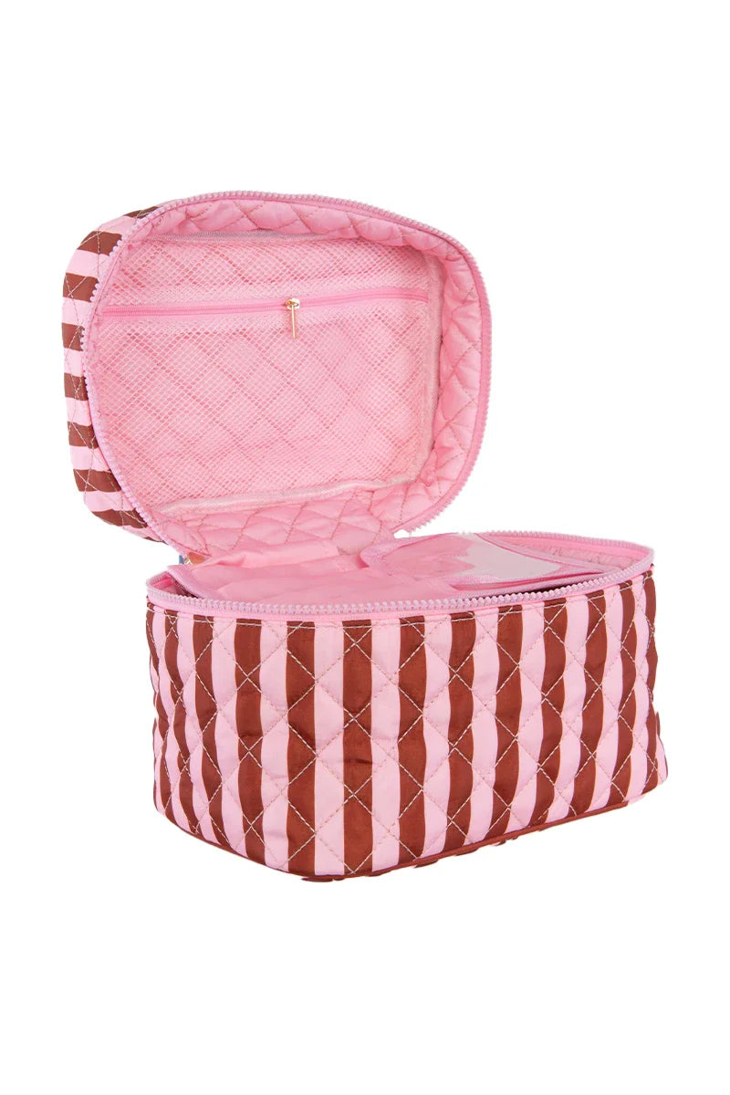 The Katydid Pink and Wine Striped Quilted Makeup Bag features vertical stripes, a pink interior, and a mesh zip pocket—ideal as a travel pouch for organizing your beauty essentials.