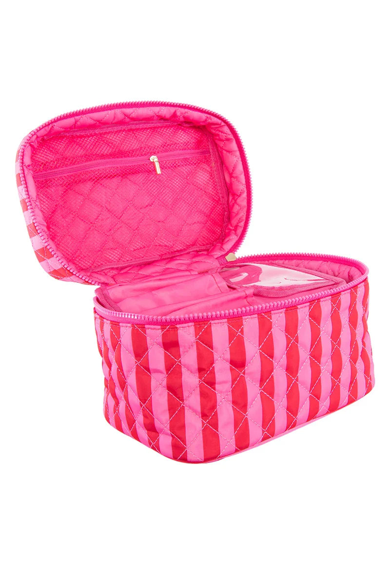 The Katydid Pink and Hot Pink Striped Make Up Bag features a quilted design, spacious interior, and zippered mesh pocket inside the lid—perfect for travel and storing your beauty essentials.