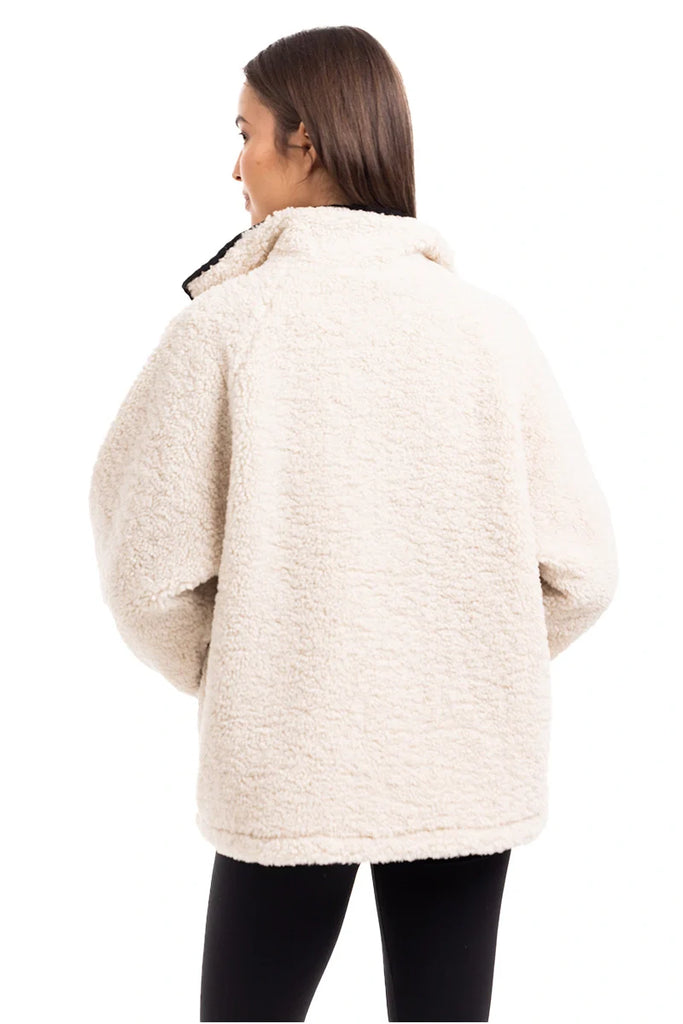A woman with long brown hair, seen from behind, wears the Katydid Cream Womens Sherpa Lace Trim Jacket and black leggings against a plain white background.