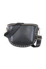 The Katydid Black Gold-Studded Crossbody Bag features a chic half-moon shape, gold stud detailing along the bottom, a gold zipper, and an adjustable black strap with gold hardware.