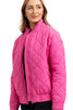 A woman with light brown hair smiles while wearing the Katydid Hot Pink Sporty Diamond Quilted Jacket, featuring a zipper front and diamond stitching. This stylish, lightweight jacket is perfect for fall and stands out against a white background.