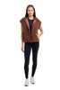 A woman faces forward in the Katydid Brown Corduroy Quilted Vest layered over black leggings and top with white sneakers, creating an easy fall look against a plain white background.