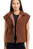 A woman models the Katydid Brown Corduroy Quilted Vest over a black top, standing against a white background—a stylish and effortless fall fashion look.