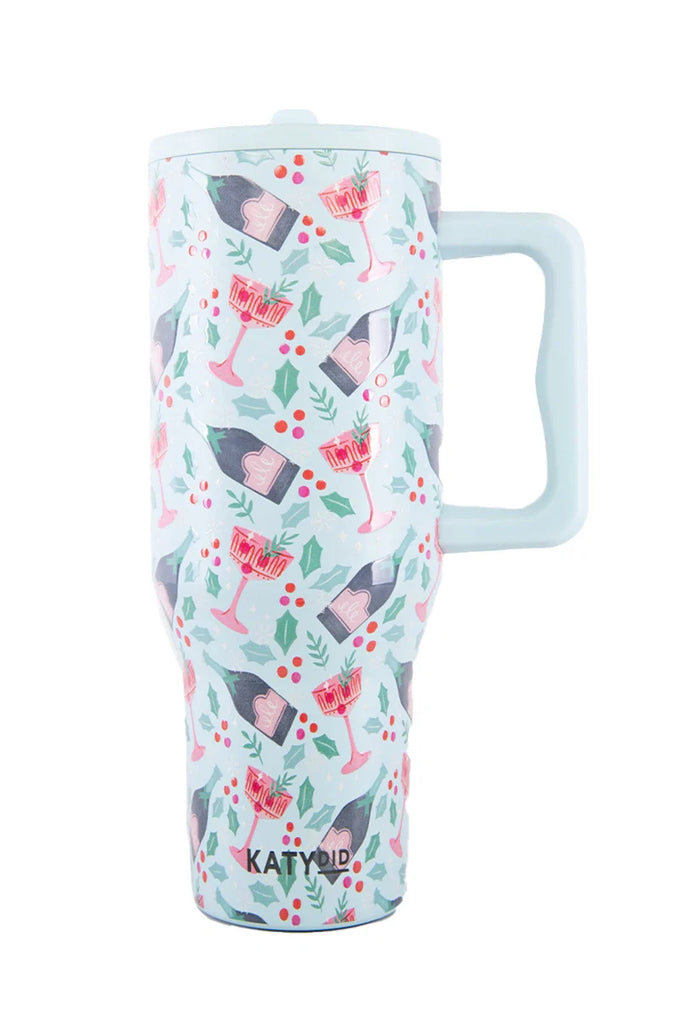 Celebrate anywhere with the Katydid Holiday Champagne Cheerful Design Flip Top Tumbler—tall, insulated, easy-grip handle, spill-proof, and featuring festive wine glasses, champagne bottles, holly leaves  berries on a light background.