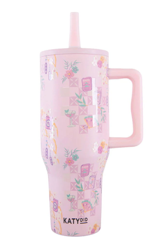 The Katydid Mahjong Pieces Hydration Tumbler features a tall, pink design with a large handle, straw lid, and floral cocktail pattern—an ideal addition to any mahjong lover’s cup collection. “KATYDID” is printed near the base.
