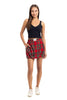 A woman stands facing forward in a sleeveless black top, Katydid Royal Stewart Plaid Mini Bubble Skirt with pockets and visible label, and white sneakers. She smiles slightly against a white background—ideal for a festive Christmas party look.