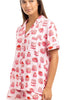 A woman models the Katydid Girly Cakes PJ Shorts Set, featuring light pink short sleeves and shorts with a playful cake print—perfect for those who love fun, girly pajamas.