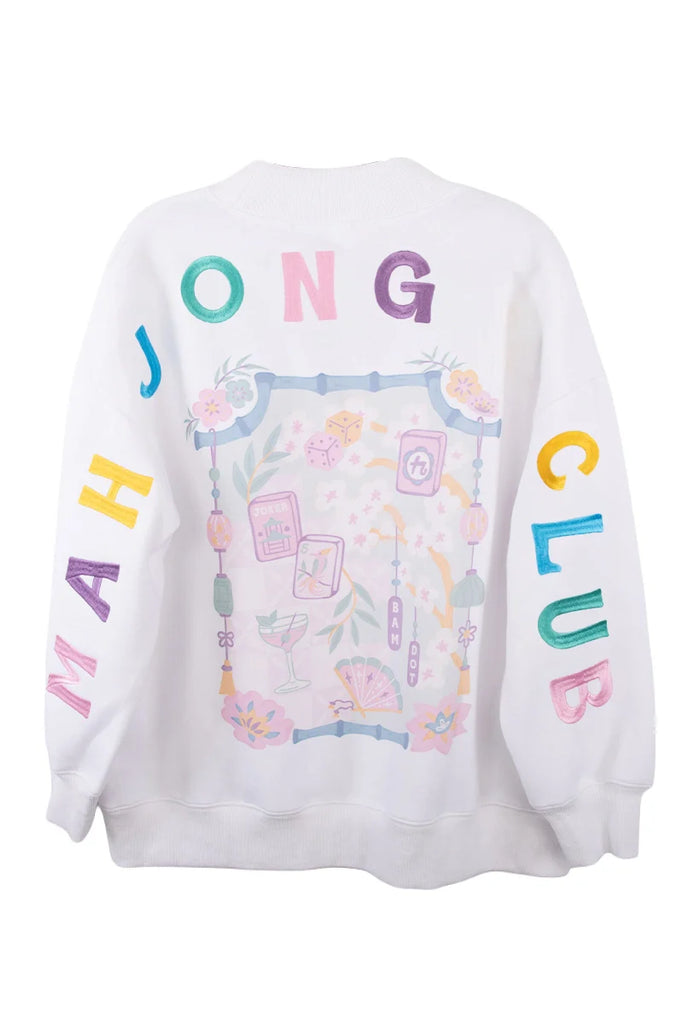 The Katydid Mahjong Club Mockneck Pullover features colorful “MAHJONG CLUB” lettering on the sleeves and back, plus pastel mahjong tiles, flowers, and game-themed designs—an ideal pick for your next girls’ game night.