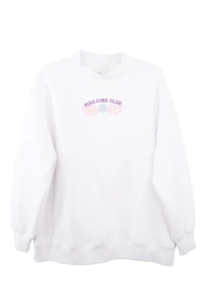 The Katydid Mahjong Club Mockneck Pullover is a white sweatshirt with “MAHJONG CLUB” in pink plus pastel mahjong tiles and flowers on the chest—perfect for girls’ game night.