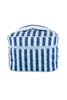 The Katydid Light Blue and Navy Striped Makeup Travel Bag is a quilted rectangular pouch with a top handle and chic vertical stripes—ideal for travel or daily use.