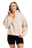 A woman models the Katydid Confetti Print Womens Pullover with a half-zip collar and peach trim, paired with black shorts, standing against a white background and smiling slightly.