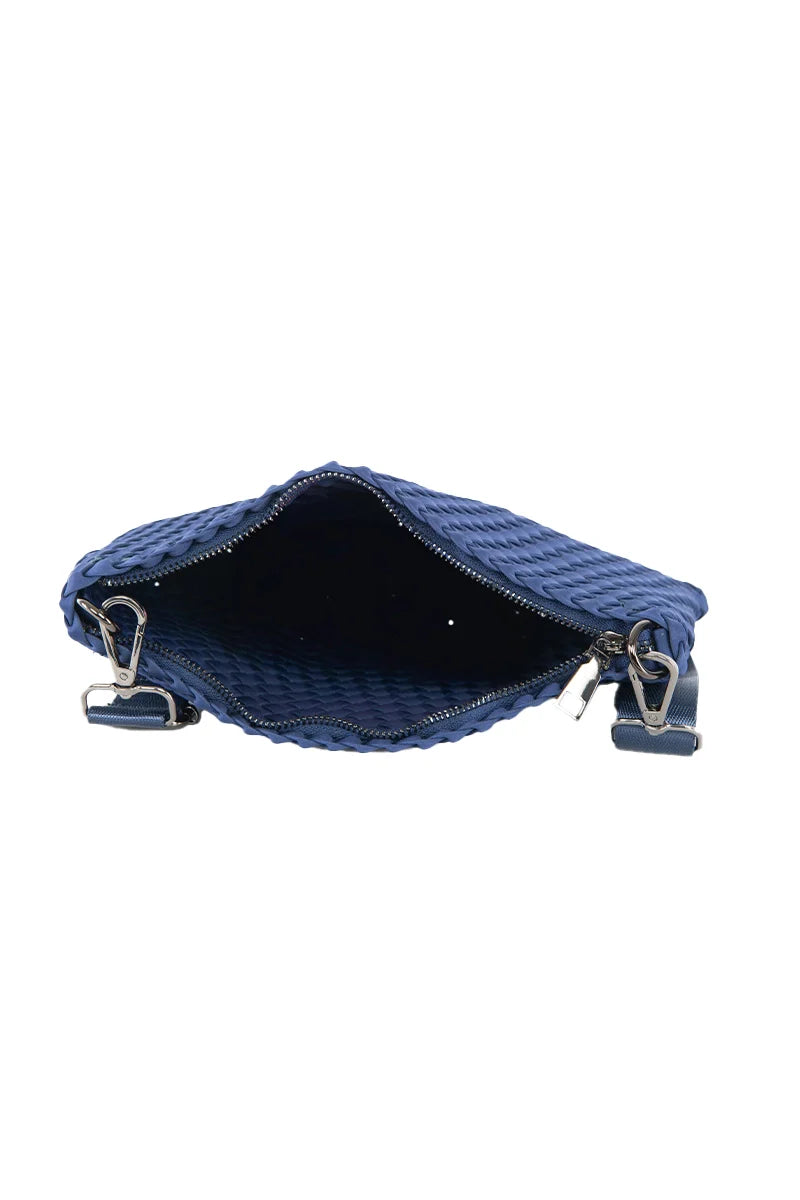 The Katydid Navy Woven Everywhere Small Crossbody is shown from above with its zippered opening wide, revealing a spacious dark interior and two metal clasps on either side for an adjustable strap.