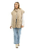 A woman wears the Katydid Beige Oversized Garment Washed Vest over a white long-sleeve shirt with light blue jeans and white sneakers, standing against a crisp white background and smiling slightly.
