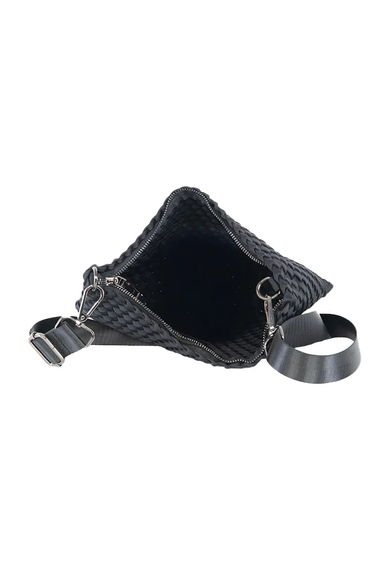 The Katydid Black Woven Everywhere Crossbody Women bag is shown open with a spacious interior. This everyday crossbody has a wide adjustable strap, silver zipper, metal hardware, and is made of durable, waterproof neoprene.