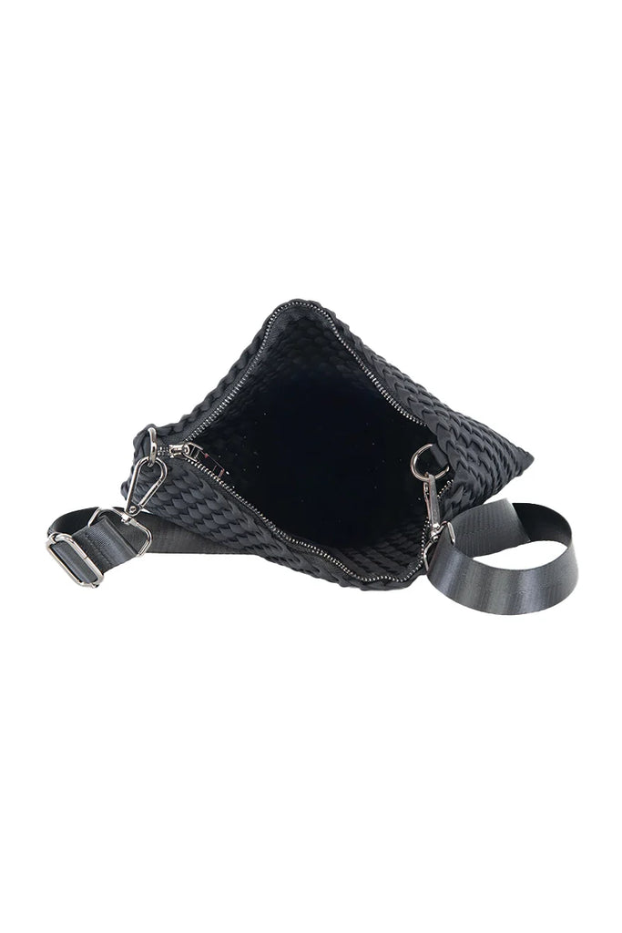 The Katydid Black Woven Everywhere Crossbody Women bag is shown open with a spacious interior. This everyday crossbody has a wide adjustable strap, silver zipper, metal hardware, and is made of durable, waterproof neoprene.