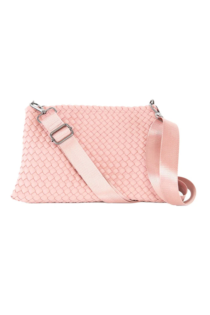 The Katydid Blush Woven Everywhere Crossbody Bag features a wide matching adjustable strap and silver hardware, shown against a white background.