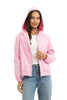 A woman smiles against a white background, wearing the Katydid Pink Lightweight Casual Hooded Jacket over a white t-shirt and blue jeans.