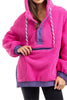 A woman wears the Katydid Hot Pink Two-Toned Sherpa Pullover Jacket, featuring a purple kangaroo pocket, purple trim, and white drawstrings. The cozy, textured pullover is shown from her shoulders to thighs.