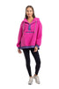 A woman faces forward in a Katydid Hot Pink Two-Toned Sherpa Pullover Jacket with white drawstrings, paired with black leggings and white sneakers. The cozy pullover stands out against the plain white background.
