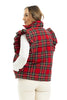 A woman wearing the Katydid Royal Stewart Plaid Ruffle Puffer Vest over a white long-sleeve shirt and cream pants stands facing away—an ideal festive holiday look.