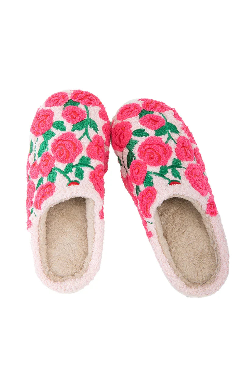 The Katydid Whimsical Roses Fuzzy Slippers for women are cozy, cream-colored sherpa slippers featuring soft linings and bright pink and red embroidered roses with green leaves on the outside.