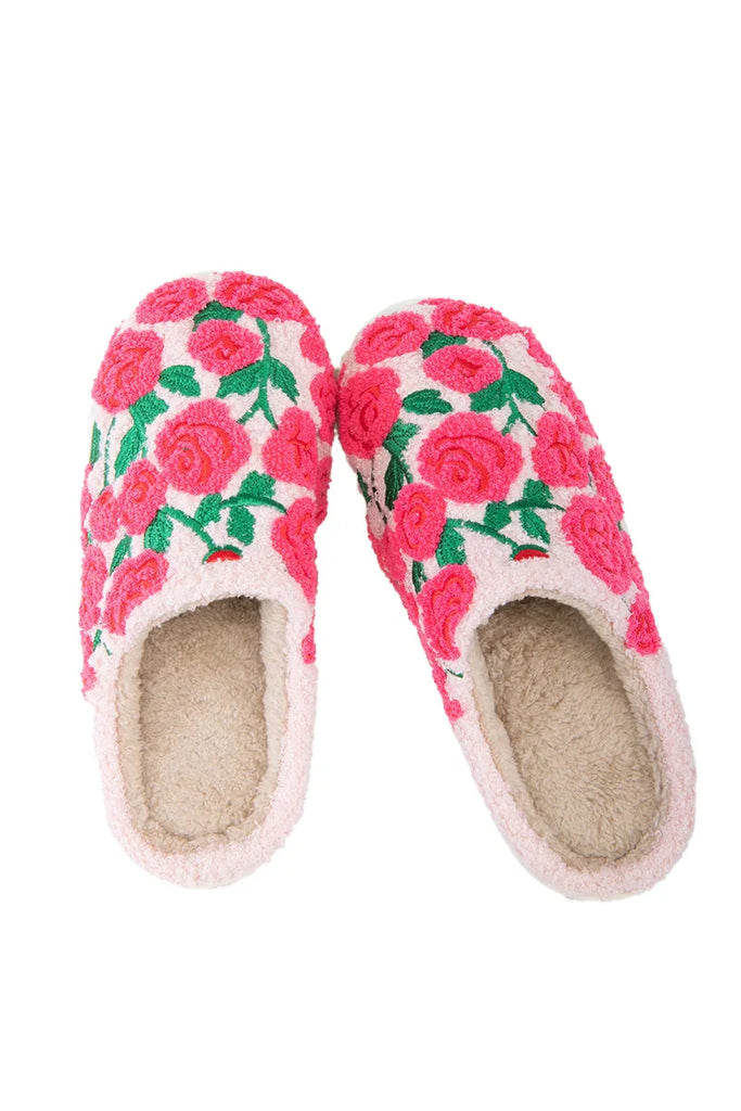 The Katydid Whimsical Roses Fuzzy Slippers for women are cozy, cream-colored sherpa slippers featuring soft linings and bright pink and red embroidered roses with green leaves on the outside.
