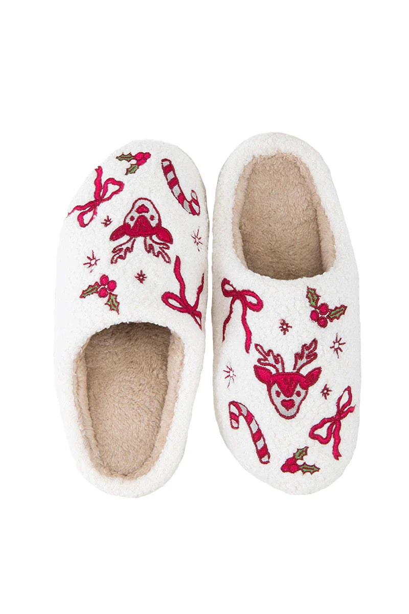 Katydid’s Bow Reindeer Winter Slippers feature a cozy beige sherpa lining and festive red and green embroidery—reindeer faces, holly, candy canes, and bows—making them the perfect Christmas slippers.