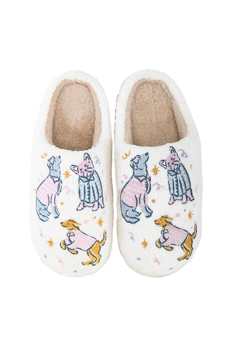 Katydid’s Posh Pets Women Slippers are white sherpa, tan-lined, and feature cartoon dogs in pajamas among stars and moons—cozy, fun slippers perfect for any pet lover.