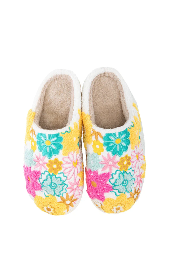 The Katydid Spring Flowers House Slippers for Women feature a cozy, fuzzy texture and colorful yellow, pink, teal, and green floral patterns on a crisp white background.