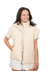 Woman wearing a beige vest over a white shirt and shorts on a white background
