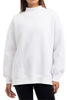 A person is shown from mid-thigh up, facing forward, wearing the Katydid Cloud White Essential Mockneck Sweatshirt with long sleeves and black pants; their face is not visible.