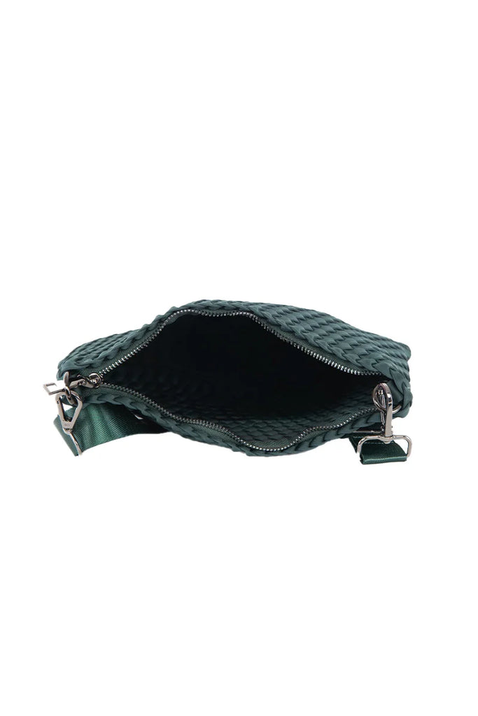 The Katydid Forest Green Woven Everywhere Crossbody is shown from above, highlighting its empty interior, zippered opening, and an attached shoulder strap for hands-free wear.