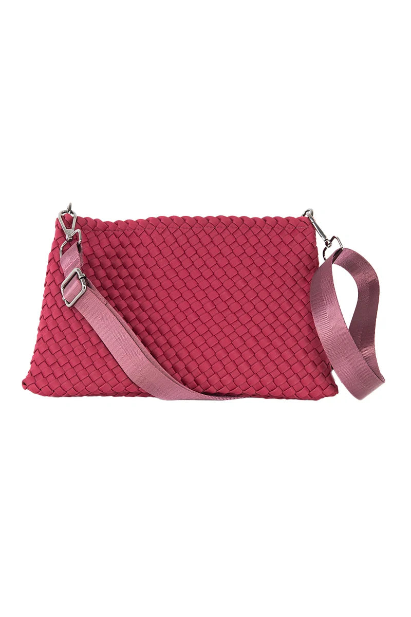 The Wine Woven Everywhere Crossbody by Katydid is a rectangular dark pink handbag with a textured pattern and a detachable wide light pink strap with silver hardware—an ideal statement accessory for fall.
