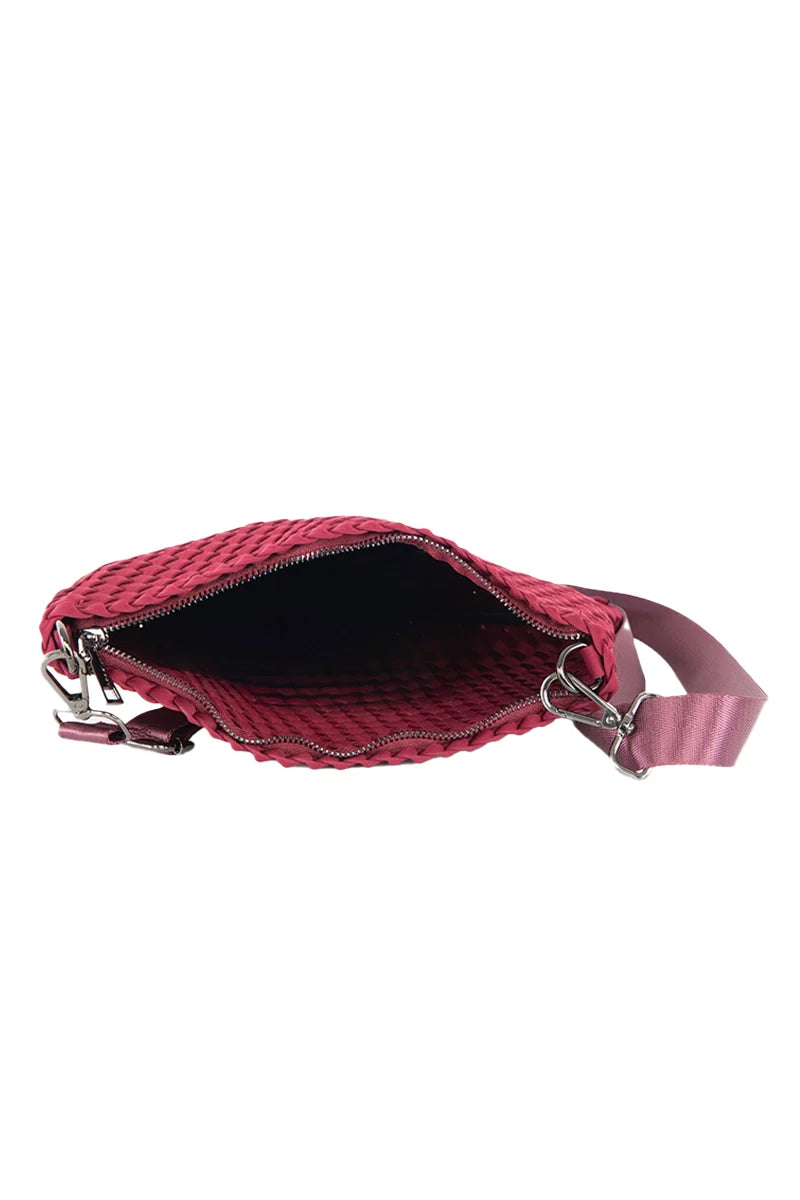 A top view of the Katydid Wine Woven Everywhere Crossbody shows its open, empty quilted design in maroon with a zipper closure and matching adjustable strap—a spacious fall accessory perfect for everyday use.