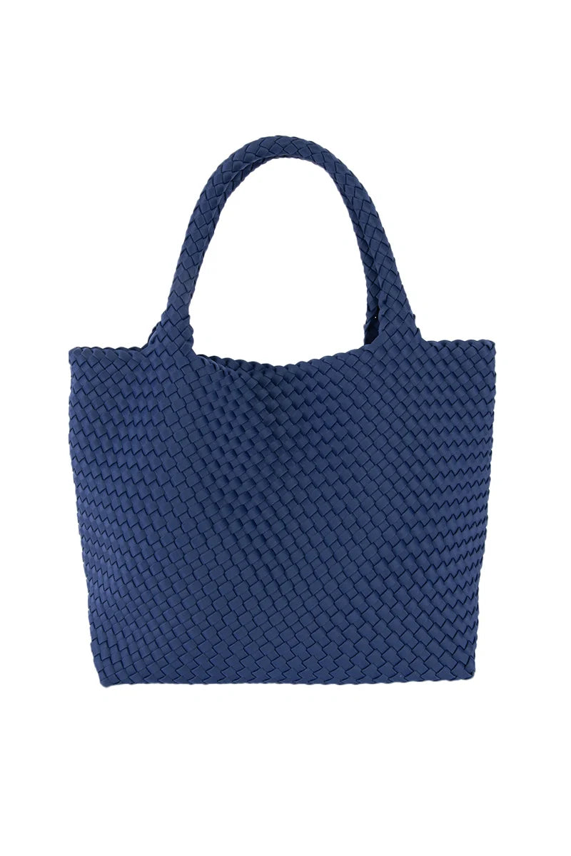 The Katydid Navy Lightweight Woven Tote features a waterproof neoprene finish and two sturdy handles, shown standing upright against a plain white background.