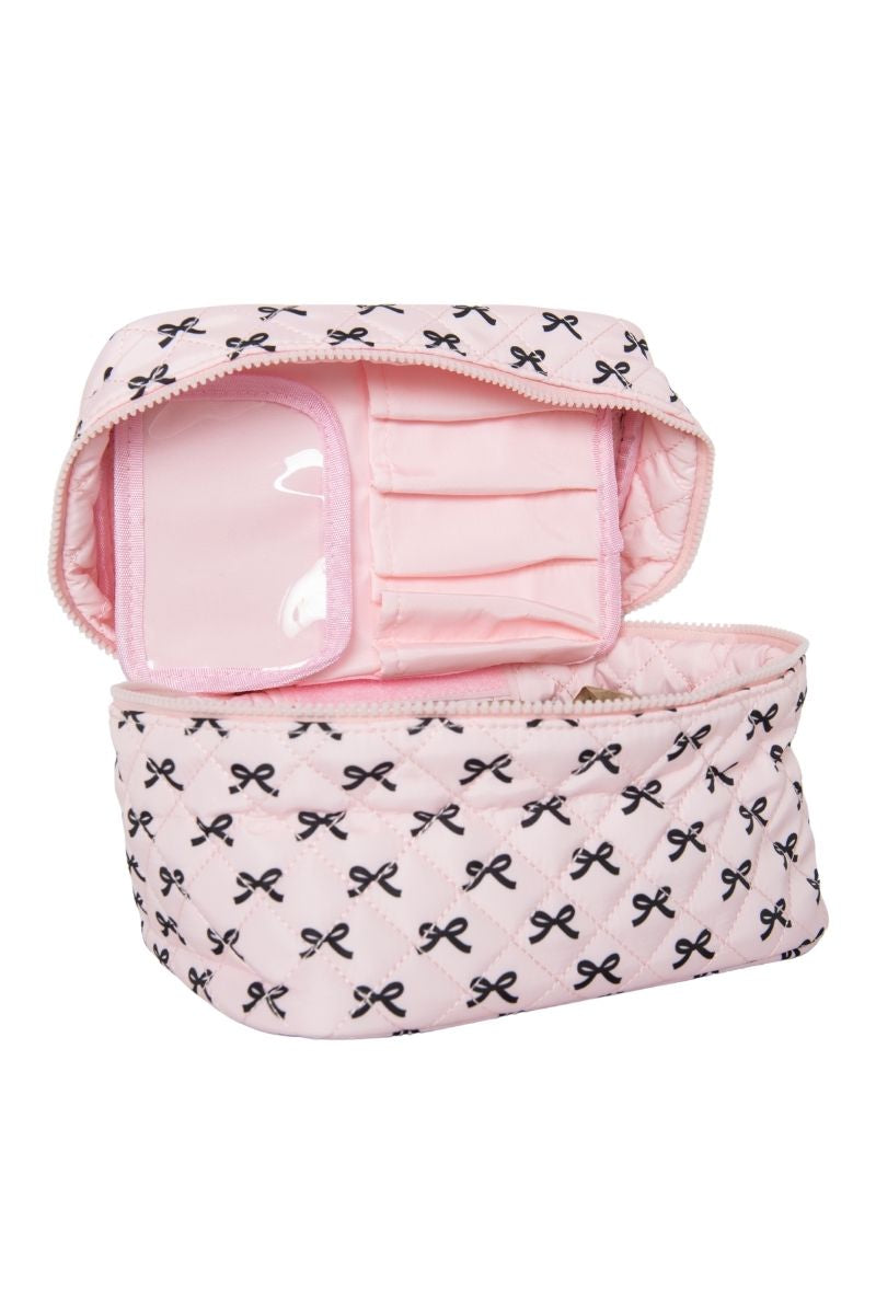 The Katydid Mini Black Bows Travel Cosmetic Bag is a pink quilted makeup bag with a zippered lid, black bow accents, and inner pockets plus a clear section—ideal for organizing your beauty essentials on the go.