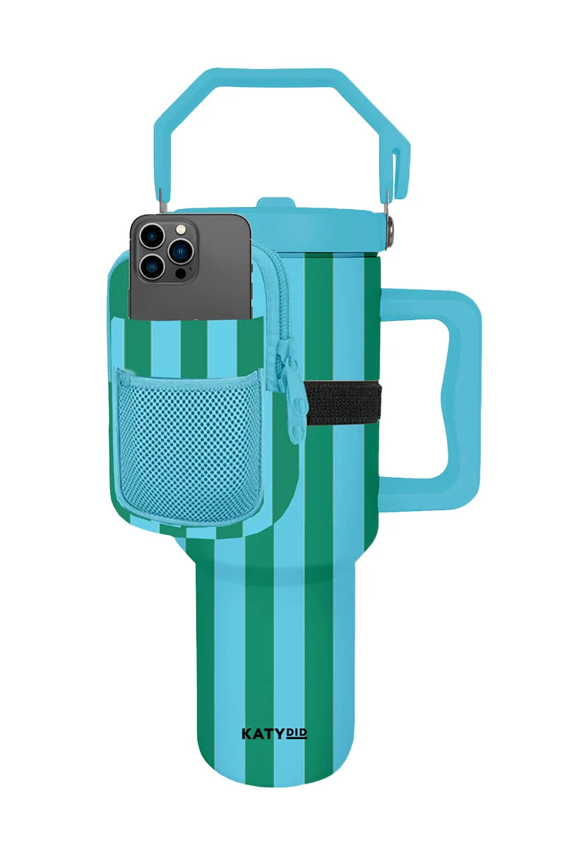 The Katydid Aqua and Green Striped Tumbler Pouch includes a handle, lid, matching blue strap, neoprene pouch, mesh smartphone pocket, and has KATYDID on the bottom.
