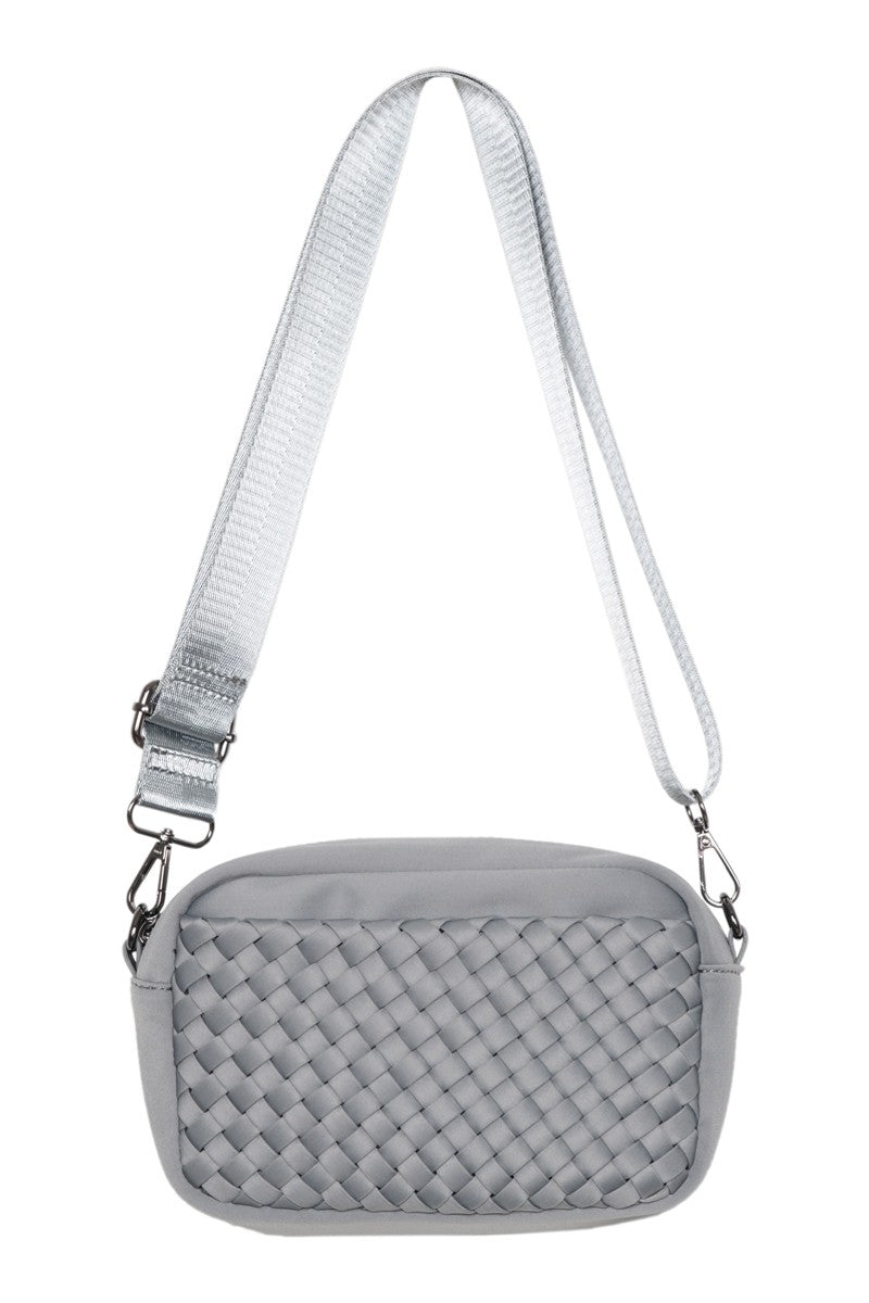 The Katydid Gray Woven Cute Crossbody Bag is a small, minimalist rectangular neoprene bag in light gray, featuring a textured front panel, smooth sides, and an adjustable strap with metal clasps.
