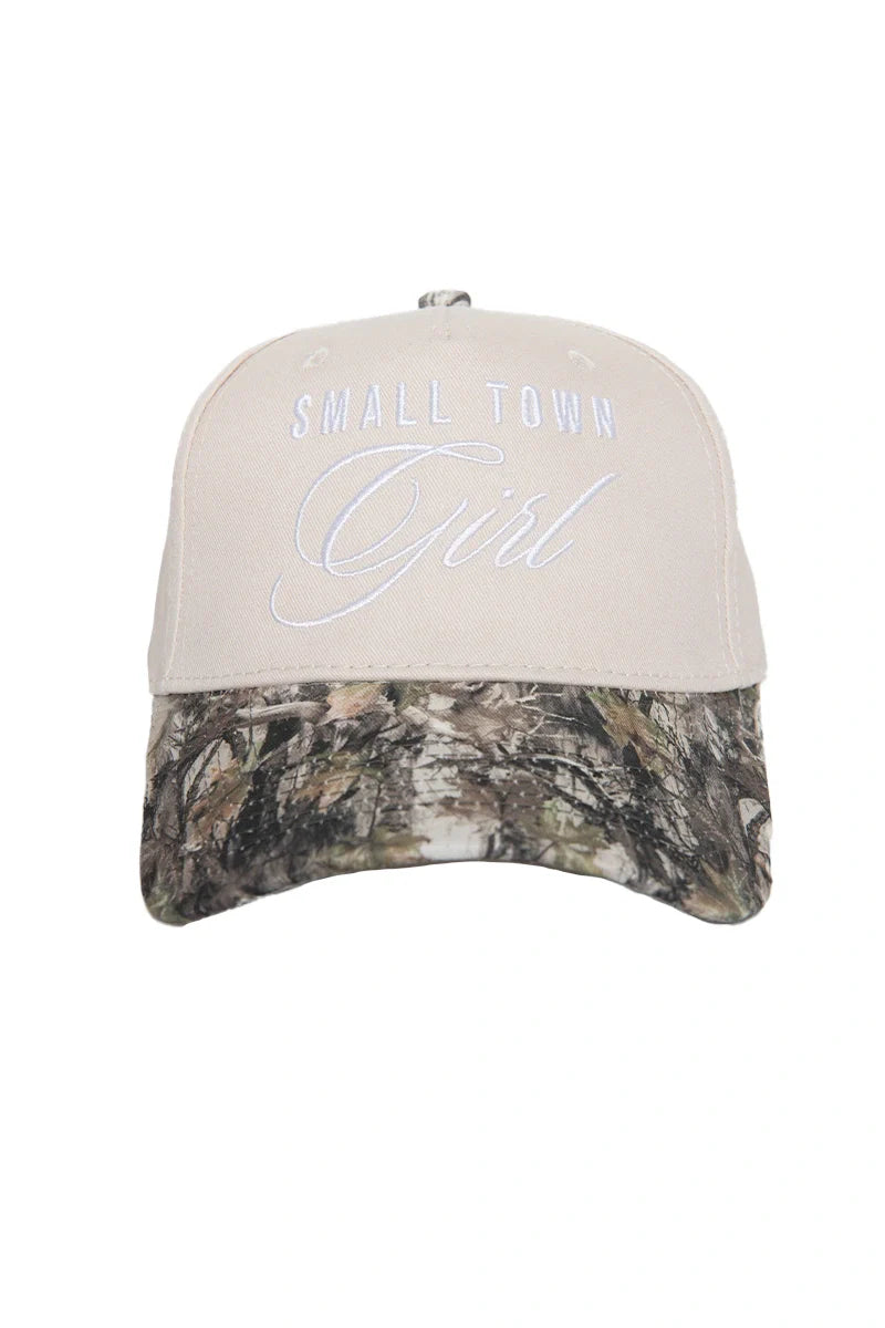 The Katydid Small Town Girl Vintage Trucker Hat for women features beige fabric, white front embroidery, and a camo-print brim—a charming country-cute cap ideal for relaxed days.