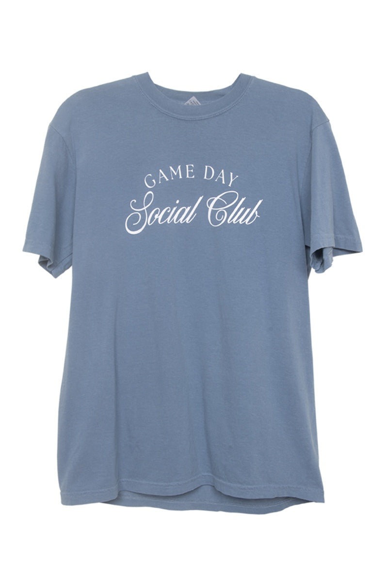 The Katydid Game Day Social Club Graphic Tee is a women’s blue Comfort Colors T-shirt with short sleeves and white text in mixed fonts, combining style and comfort for any occasion. Displayed against a plain white background.